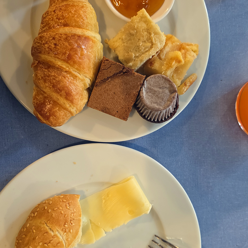 Breakfast: croissant, cake, and bread